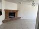 Living room area with brick fireplace, tiled flooring, ceiling fan, and white walls at 5170 S Pearl St, Las Vegas, NV 89120