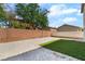 Backyard with decorative rock landscaping and a strip of artificial grass at 529 Fork Mesa Ct, Henderson, NV 89015