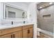 Modern bathroom with double sink vanity with wood cabinets and stylish mirror at 529 Fork Mesa Ct, Henderson, NV 89015