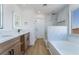 Modern bathroom with double vanity, bathtub, sleek fixtures, and bright natural light at 529 Fork Mesa Ct, Henderson, NV 89015