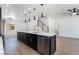 The modern kitchen features a large island with a stainless steel dishwasher and gold hardware at 529 Fork Mesa Ct, Henderson, NV 89015