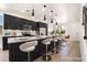 Modern kitchen with sleek black cabinets, stainless appliances, a large island, and stylish pendant lighting at 529 Fork Mesa Ct, Henderson, NV 89015