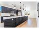Modern kitchen with large island with white countertops, stainless steel appliances, and decorative pendant lights at 529 Fork Mesa Ct, Henderson, NV 89015