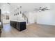 Modern kitchen and open floor plan with sleek black cabinets and light colored flooring at 529 Fork Mesa Ct, Henderson, NV 89015