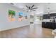 Bright living room featuring multiple windows, wood floors, and an open concept to the kitchen at 529 Fork Mesa Ct, Henderson, NV 89015