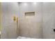 Stylish shower featuring gray tile, gold fixtures and a convenient in-wall niche at 529 Fork Mesa Ct, Henderson, NV 89015