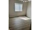 Bedroom featuring laminate floors, window and ceiling fan with light at 5512 Del Lago Dr, Las Vegas, NV 89130