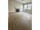 Spacious living room featuring sleek flooring, fireplace, and ample natural light at 5512 Del Lago Dr, Las Vegas, NV 89130