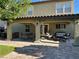 Covered backyard patio with a grill, patio furniture, and landscaped yard at 5516 Coyote Falls Ct, Las Vegas, NV 89131