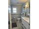 Bathroom featuring a ladder shelf, window, and modern sink provides storage and light at 5516 Coyote Falls Ct, Las Vegas, NV 89131