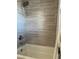 Tiled shower with modern fixtures and a shower head provide a luxurious showering experience in this bathroom at 5516 Coyote Falls Ct, Las Vegas, NV 89131