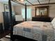 Bedroom with a four post bed, dark wood floors, dresser and mirror, and shuttered windows at 5516 Coyote Falls Ct, Las Vegas, NV 89131