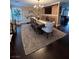 Elegant dining room with rustic wood table, chandelier, and custom entertainment center at 5516 Coyote Falls Ct, Las Vegas, NV 89131
