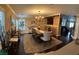 Open concept dining room with chandelier, stylish furniture, and adjacent living area at 5516 Coyote Falls Ct, Las Vegas, NV 89131
