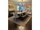 Spacious dining room with wooden table, bench seating, and stylish decor on a jute rug at 5516 Coyote Falls Ct, Las Vegas, NV 89131