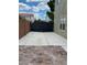 The long driveway is secured by a metal privacy gate with a brick-paved patio in the foreground at 5516 Coyote Falls Ct, Las Vegas, NV 89131
