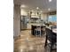 Kitchen boasts stainless steel appliances, custom cabinets, an island, and beautiful tile flooring, offering both style and function at 5516 Coyote Falls Ct, Las Vegas, NV 89131