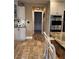 Well-lit kitchen featuring white cabinets, stainless steel oven and stone tile flooring at 5516 Coyote Falls Ct, Las Vegas, NV 89131
