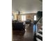 Comfortable living room featuring hardwood floors, a ceiling fan, and ample natural light at 5516 Coyote Falls Ct, Las Vegas, NV 89131
