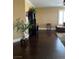 Living room with dark wood floors and a black cabinet is bathed in natural light from the window at 5516 Coyote Falls Ct, Las Vegas, NV 89131