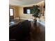 This living room features a large TV and dark hardwood floors at 5516 Coyote Falls Ct, Las Vegas, NV 89131