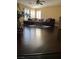 A well-lit living room space with wood floors and a comfortable sofa at 5516 Coyote Falls Ct, Las Vegas, NV 89131
