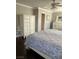 This main bedroom features an armoire and dresser set along with dark wood flooring at 5516 Coyote Falls Ct, Las Vegas, NV 89131