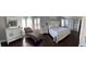 Luxurious main bedroom with hardwood floors, elegant furnishings, and ample natural light at 5516 Coyote Falls Ct, Las Vegas, NV 89131