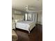 This main bedroom features dark wood floors, a ceiling fan, and great natural light at 5516 Coyote Falls Ct, Las Vegas, NV 89131