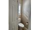 Convenient powder room with a toilet and a window at 5516 Coyote Falls Ct, Las Vegas, NV 89131