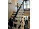 Staircase with black treads, white risers and dark stained railing at 5516 Coyote Falls Ct, Las Vegas, NV 89131