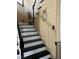 Staircase with black treads, white risers and owl wall decor at 5516 Coyote Falls Ct, Las Vegas, NV 89131