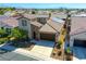 Aerial view of a two-story home featuring a brick facade, solar panels, and well-maintained landscaping at 5650 Pleasant Palms St, North Las Vegas, NV 89081