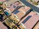 Aerial view of residential homes with solar panels, backyard pools, and manicured landscaping in a neighborhood setting at 5650 Pleasant Palms St, North Las Vegas, NV 89081