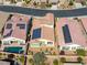 An aerial view of homes with solar panels, landscaped yards, and pools in a residential neighborhood setting at 5650 Pleasant Palms St, North Las Vegas, NV 89081
