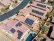 An aerial view showing rooftops with solar panels, manicured yards, and swimming pools in a residential community at 5650 Pleasant Palms St, North Las Vegas, NV 89081