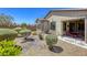 Backyard featuring desert landscaping, small bushes, and a covered patio with outdoor seating at 5650 Pleasant Palms St, North Las Vegas, NV 89081