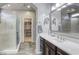 Beautiful bathroom with tiled shower, double sinks, and open walk-in closet at 5650 Pleasant Palms St, North Las Vegas, NV 89081