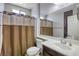 Bathroom with single sink vanity, toilet, and shower/tub combination with a curtain at 5650 Pleasant Palms St, North Las Vegas, NV 89081