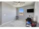 This bedroom features light gray walls, carpet flooring, and a window overlooking the mountains at 5650 Pleasant Palms St, North Las Vegas, NV 89081