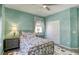 Cozy bedroom features decorative walls, a stylish metal bed frame, and neutral-toned furniture at 5650 Pleasant Palms St, North Las Vegas, NV 89081
