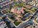 Aerial view featuring a community clubhouse, pool, sports courts, landscaped grounds, and parking areas in neighborhood at 5650 Pleasant Palms St, North Las Vegas, NV 89081