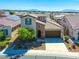 Two story home featuring a tile roof, stone accents, a well-kept yard, and set in a friendly neighborhood at 5650 Pleasant Palms St, North Las Vegas, NV 89081