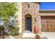 Inviting front entrance with brick accents, desert landscaping, and a decorative outdoor urn at 5650 Pleasant Palms St, North Las Vegas, NV 89081