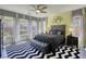 Stylish main bedroom suite with ample windows and ceiling fan at 5650 Pleasant Palms St, North Las Vegas, NV 89081