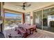 This outdoor patio features a fireplace, ceiling fan, and a dining table for enjoying outdoor meals at 5650 Pleasant Palms St, North Las Vegas, NV 89081
