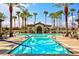 Resort-style pool surrounded by palm trees and lounge area, perfect for relaxation and entertainment at 5650 Pleasant Palms St, North Las Vegas, NV 89081