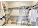 Spacious walk-in closet with ample shelving, hanging rods, and two luggage racks for organization at 5650 Pleasant Palms St, North Las Vegas, NV 89081