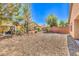 Large backyard featuring desert landscaping and mature trees at 5960 Wheat Penny Ave, Las Vegas, NV 89122