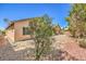 The backyard features desert landscaping and mature trees at 5960 Wheat Penny Ave, Las Vegas, NV 89122